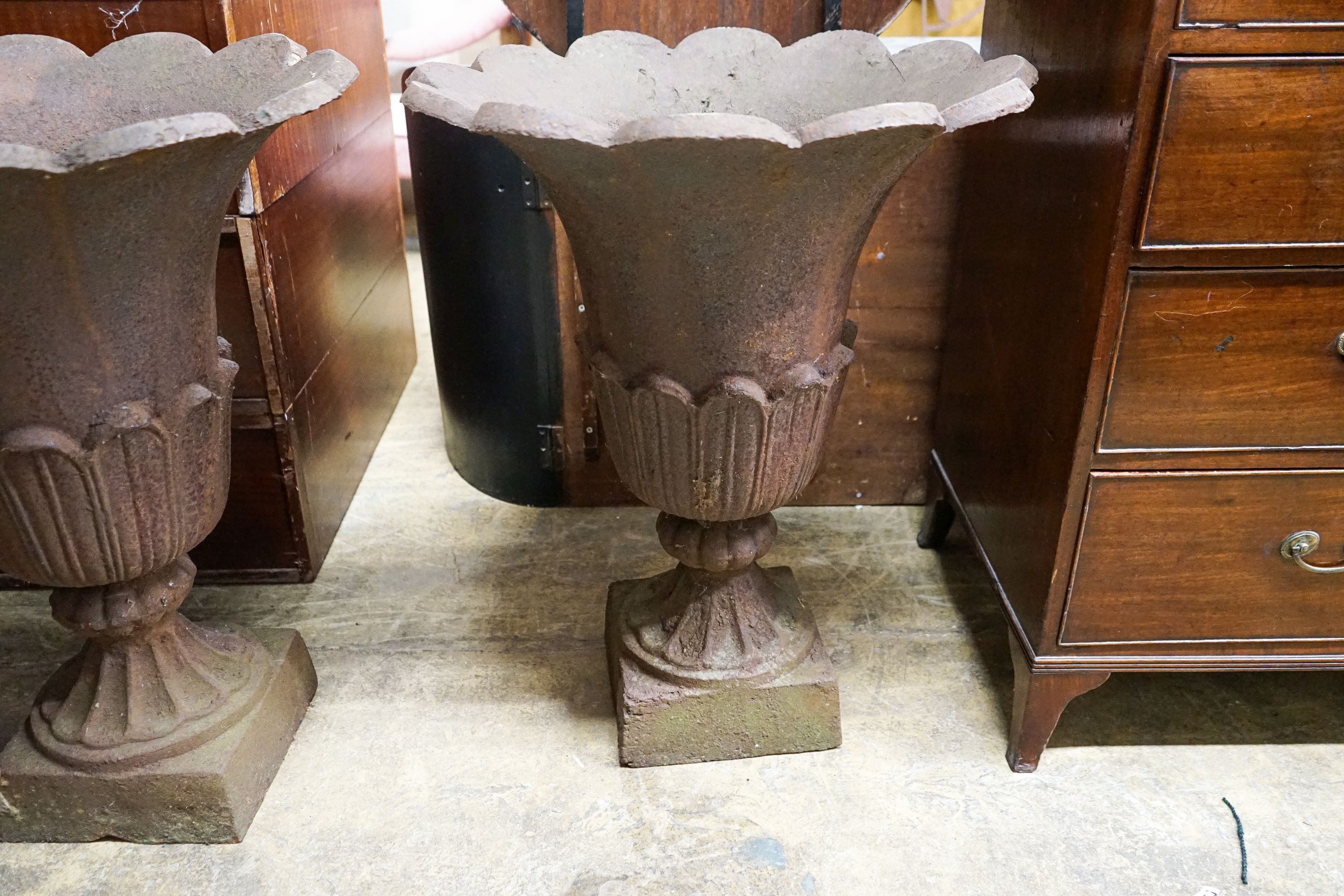 A pair of cast iron tulip urns, mid 19th century, diameter 60cm, height 75cm